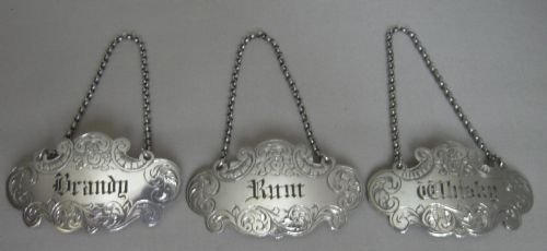 set of antique silver decanter labels